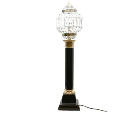 An ebonised metal and brass column form table lamp, with basket form shade on stepped plinth base, 92cm high