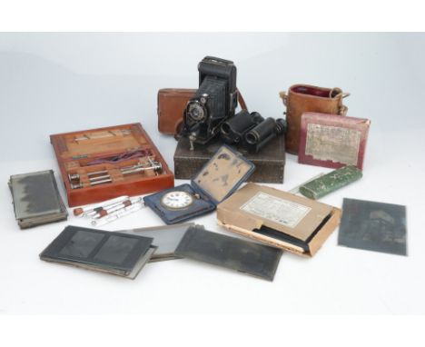 an early 20th century steel box with combination lock, folding Kodak camera, eight-day clock, half-plate nglass negatives of 