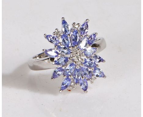 Silver and tanzanite cluster ring, the head set with many claw mounted tanzanite stones, gross weight 4.2 grams