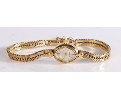 Accurist ladies 9 carat gold wristwatch, the signed silver dial with baton markers, manual wound, on a 9 carat gold bracelet,