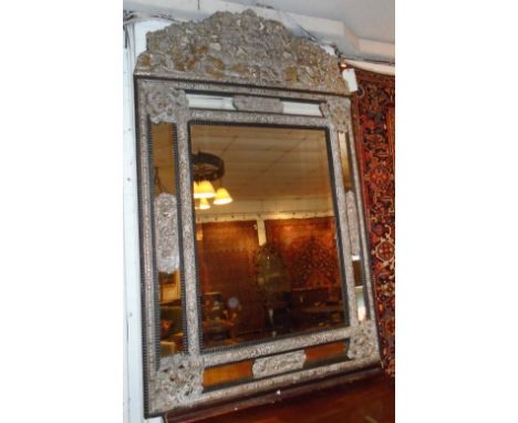 WALL MIRROR, 19th century Dutch repoussé silvered brass with crest and cushion marginal plates, 170cm H x 109cm W.