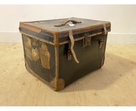 A late 19th century jappaned canvas and leather bound travelling trunk, with carry handle to top, traces of old paper labels 