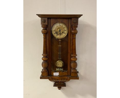A late Victorian walnut cased Vienna style wall clock, twin train movement striking on a coiled gong, lacking pediment, compl
