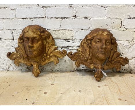A pair of cast iron garden wall mounted water fountains formed as masks, W48cm