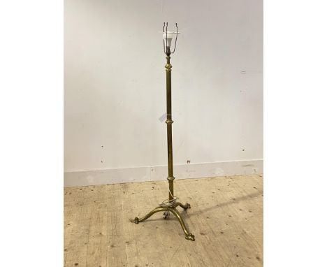 An Edwardian brass telescoping standard light, on triple splay supports