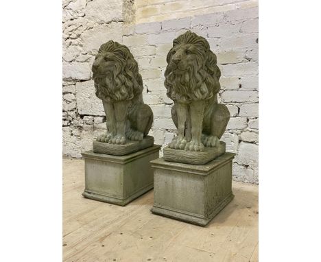A pair of reconstituted stone garden lions, modeled in a seated position atop a rectangular base, H84cm