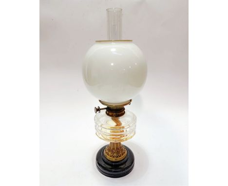 An Edwardian brass Hinks Triple No.1 mounted vitrolite based oil lamp with faceted glass reserve, complete with funnel and op