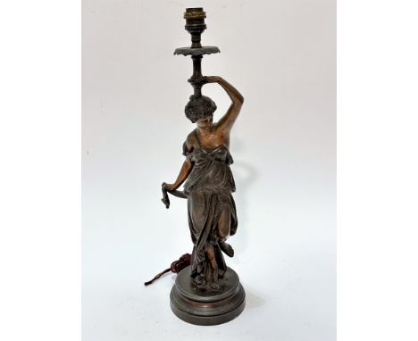 A French cast spelter figure lamp of a young lady draped in Grecian style, on circular moulded base, (including light fitting