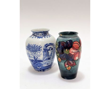 A William Moorcroft baluster vase decorated with anemone design, graduated blue ground, small chip to rim, original paper lab