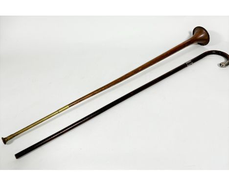 A copper coaching horn with brass mounted tip, (L 89cm) and a stained silver mounted walking stick (L 86cm) (2)