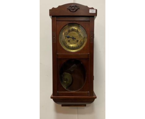 A 1930's Vienna style wall clock, the brass dial with Arabic chapter ring, twin train spring movement, complete with pendulum