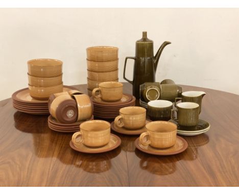 A 1970's Kiln Kraft stoneware part service, comprising six plates, eight side plates, eight soup bowls, eight cups and eight 