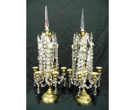 A pair of six light gilded metal and crystal Louis XV style candle girandoles, the naturalistic knopped stems on raised circu