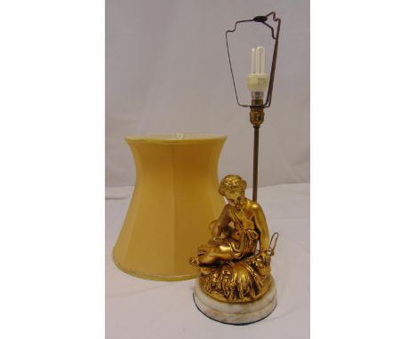 A gilded composition table lamp in the form of a classical female figurine on raised circular marble base with silk shade, 60