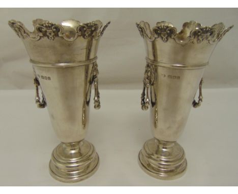 A pair of hallmarked silver vases of tapering cylindrical form, lion mask and ring side handles on raised circular bases, Lon