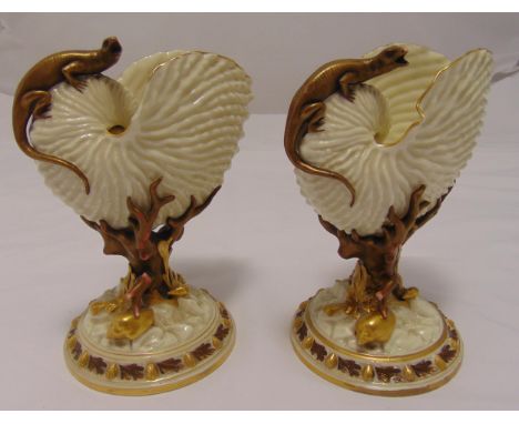 A pair of Royal Worcester Nautilus shell vases with applied lizards and coral supports on raised circular bases, stamped to t