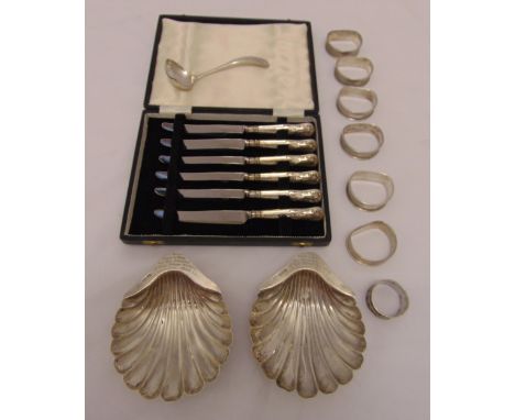 A quantity of silver and white metal to include a pair of shell shaped dishes, napkin rings, a sauce ladle and a cased set of