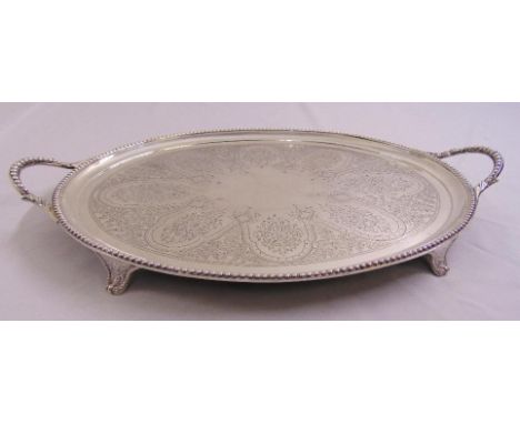 A Victorian oval hallmarked silver tea tray, engraved to the centre with leaves, scrolls and flowers, beaded borders and leaf