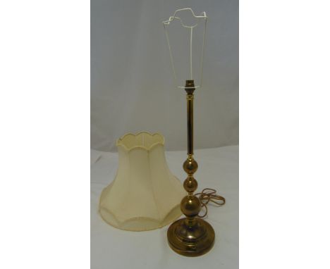 A brass table lamp of knopped cylindrical form on raised circular base and shade, 57cm (h)