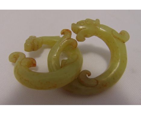 A pair of Chinese celadon jade rings in the form of dragons