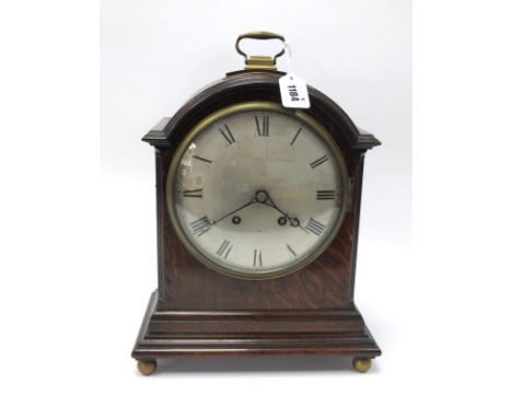 A XIX Century Oak Domed Cased Bracket Clock, on stepped base with brass carry handle and four ball feet, black Roman numerals