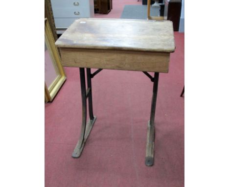 An Early/Mid XX Century Individual Oak School Desk, with sloped lift-up top, brass sliding cover to porcelain inkwell, on cas
