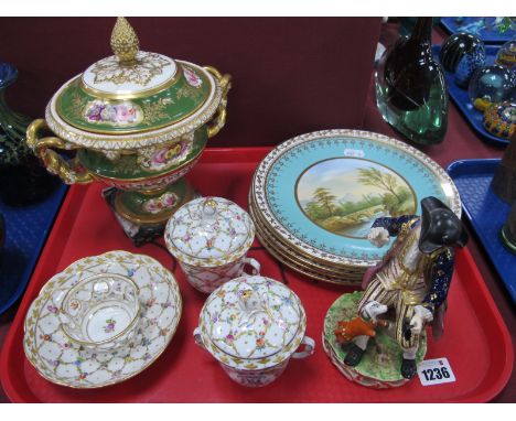 A Derby Porcelain Figure, of a seated boy and a dog wearing an orange jacket, upon a pierced scrolling circular base Red crow