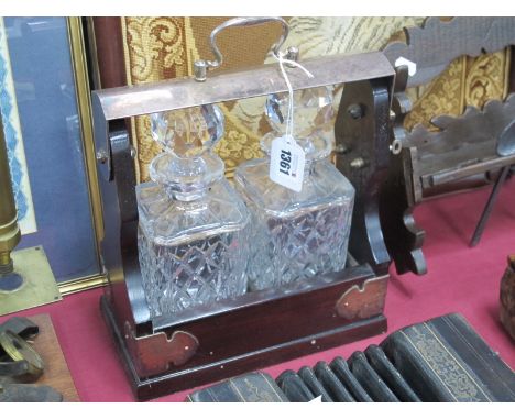 Two Bottle Tantalus, with a plated handle and mounts.
