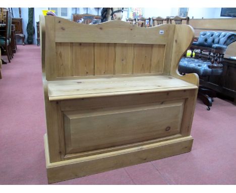 A Pine Bench, with lift-up seat revealing storage compartment, shaped sides, on plinth base, 84.5cm high, 95.5cm wide.