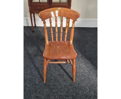 An early 20th century elm ash kitchen chair.