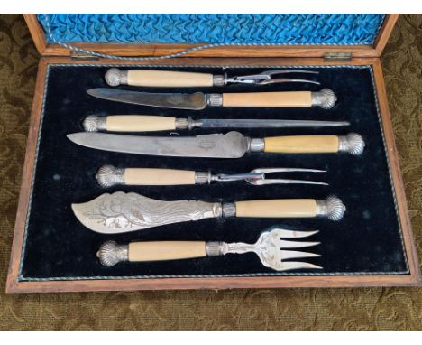 Oak cased carving and serving set by J.H. Potter, Sheffield with silver cushion crown mounts and ferrules.