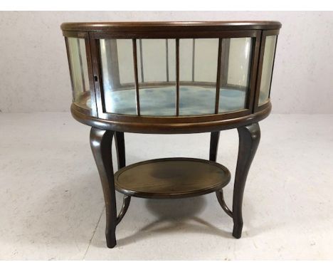 Oak framed glass panelled silver table with shelf beneath, on serpentine legs, upper glass has bevelled edge, lined with blue