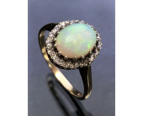 9ct yellow Gold ring set with a large Opal surrounded by diamonds all set in platinum size 'P' (Opal approx 9mm across) 