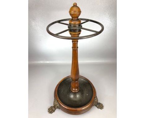 Circular umbrella /stick stand with turned central column, on claw feet, with metal drip tray, approx 61cm in height
