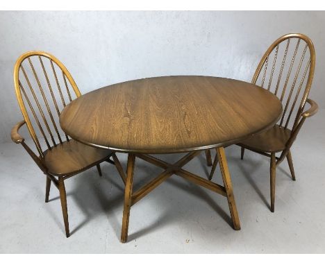 Ercol drop leaf dining table, oval top raised on four splayed square supports with 'X' stretcher, together with two Ercol car