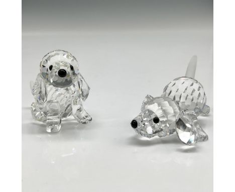 Clear crystal figures are part of the Peaceful Countryside Group. One sitting and the other playing have long ears, frosted t