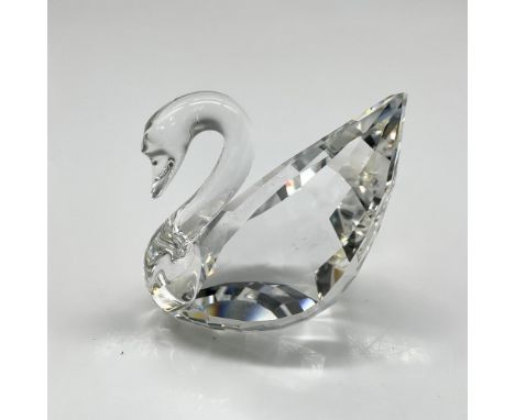 Clear crystal logo figural with smooth neck and faceted body. Swarovski backstamp. This item has its original box: 9.5"L x 4"