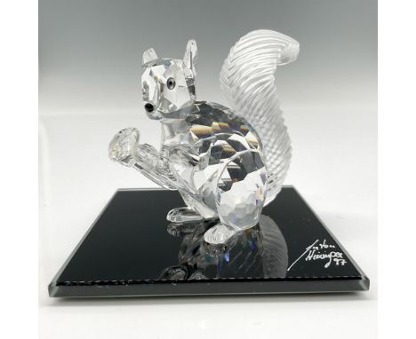 Adorable, limited edition crystal figure with frosted crystal bushy tail holding his crystal chaton, looking out with jet cry