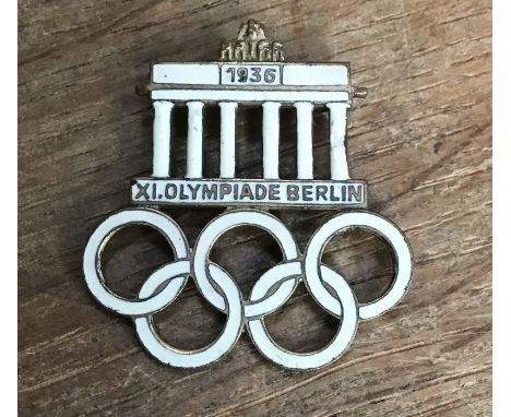1936 Berlin Olympic metal and white enamel badge in good condition. Marked ‘W.Redo Saarlauter GES . GESCH’ to back.