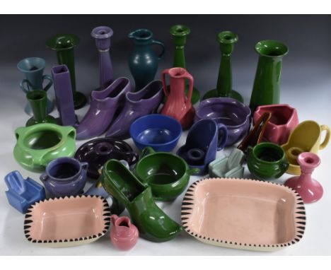 A pair of novelty Bourne Denby model shoes, in 17th century style, glazed throughout in purple; other novelty pipe stands as 