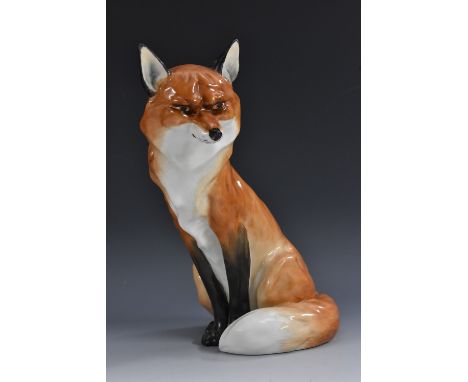A Royal Worcester model of a red fox, seated with a guileful expression, number 2993, 18cm printed mark in black