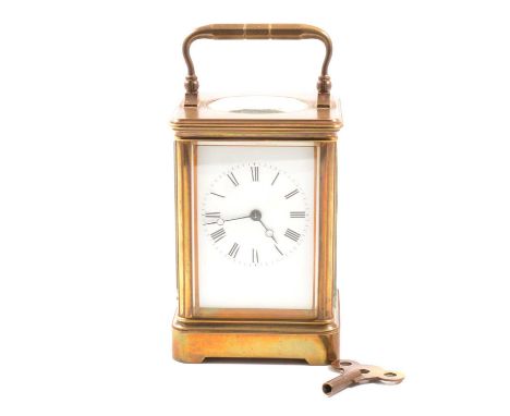 A French style carriage timepiece with white enamel dial and roman numeral chapter ring, oval bevelled glass to top revealing
