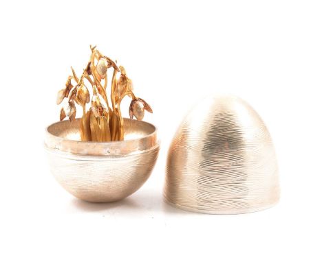 A Nicholas Plummer silver surprise egg in the manner of Stuart Devlin, the wavy lined engine turned egg with lift off top rev