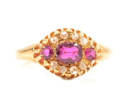 A diamond and untested pink stone ring, the oval cluster set with three graduating pink stones surrounded by eight rose cut d