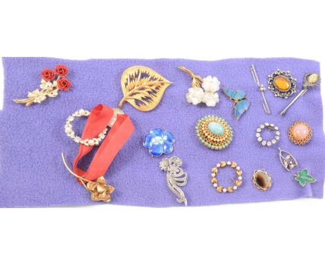 A collection of eighteen costume jewellery brooches, silver wishbone with paste set thistle; blue enamel flower stamped silve