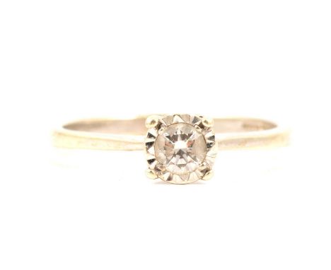 A diamond solitaire ring, the brilliant cut stone illusion set in 9 carat yellow and white gold mount ring size O, yellow gol