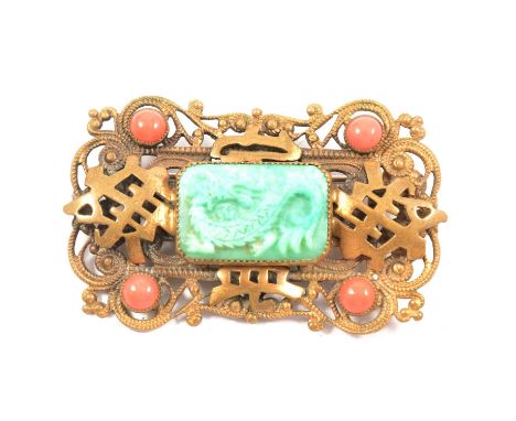 A brooch influenced by The Chinese Art Exhibition of 1935-1936, probably Max Neiger of Gablonz, a rectangular gilt metal broo