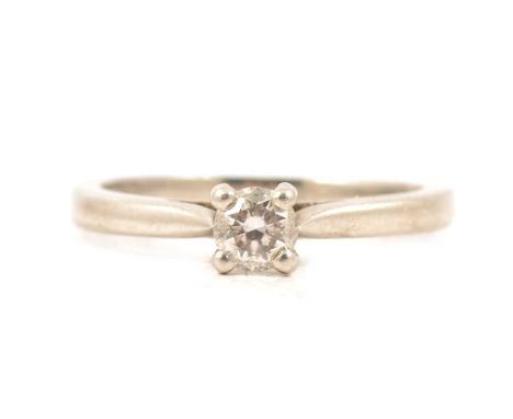 A diamond solitaire ring, the brilliant cut stone four claw set in a platinum mount ring size J, gross weight including a sma