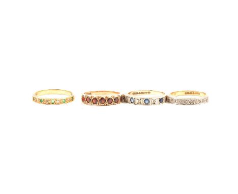 Four gemset half eternity rings, a yellow metal half eternity ring set with five emeralds and four 8 cut diamonds ring size P