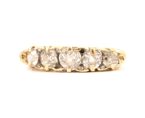 A diamond five stone half hoop ring, the old brilliant cut stones graduating in size, claw set in an all yellow gold carved c